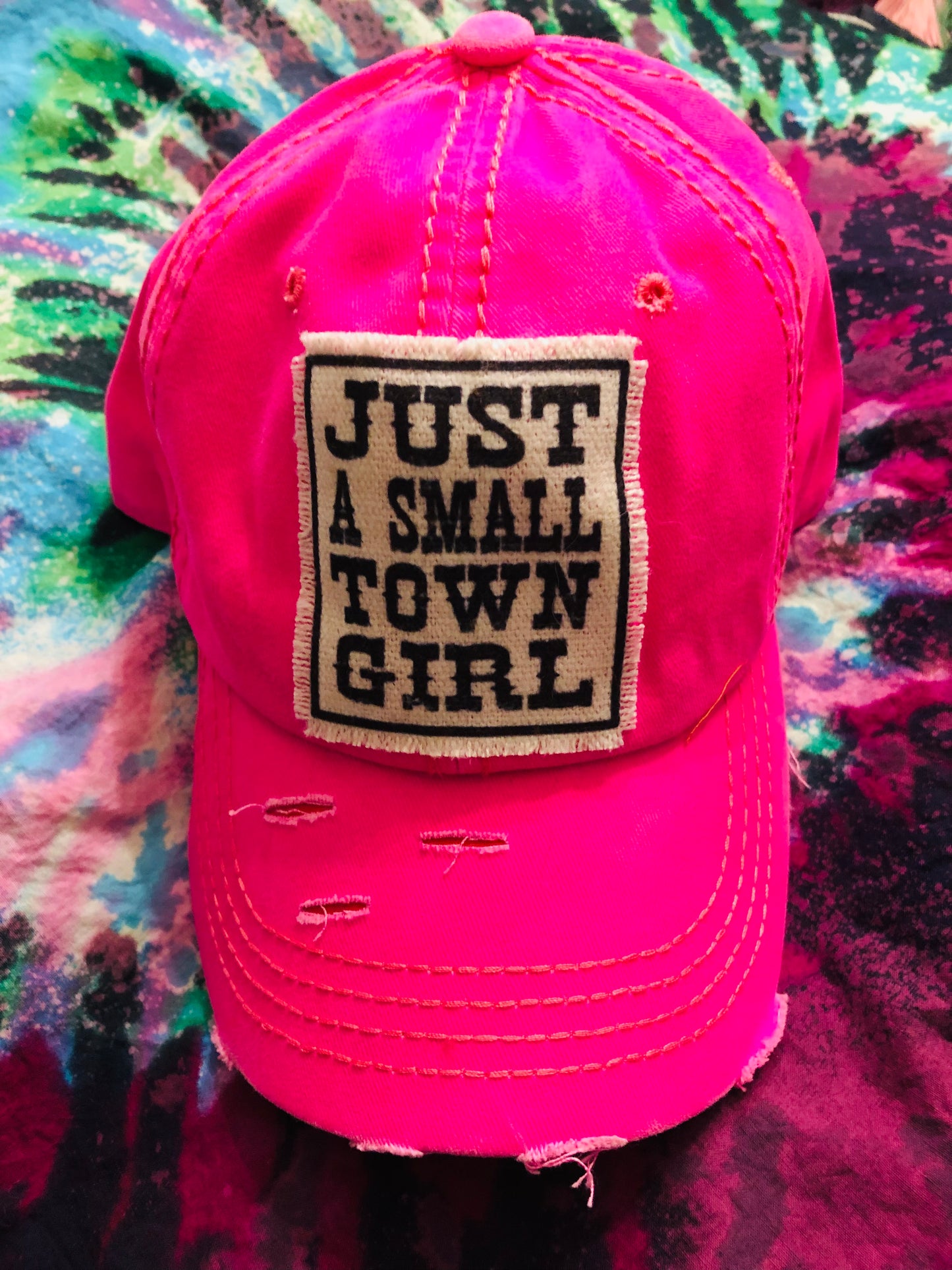 just a small town girl patch on a hot pink distressed baseball cap with a adjustable back buckle strap